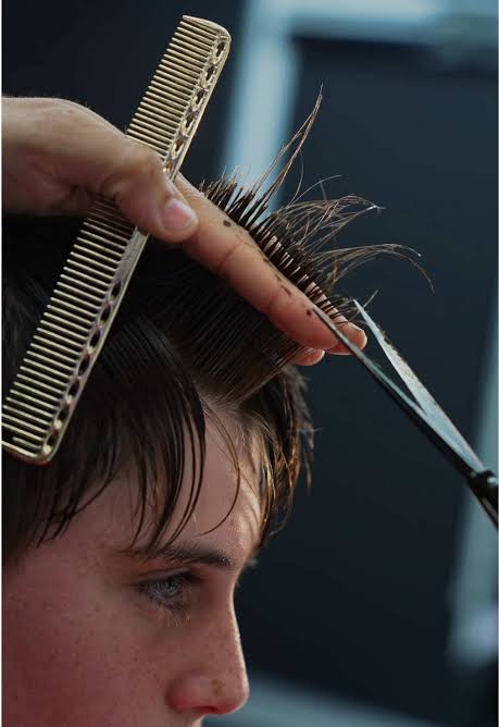 Close-up of haircut with comb and scissors