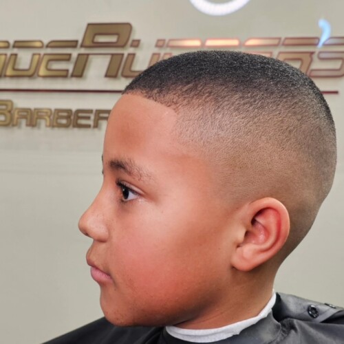 Boy with fresh fade haircut in barbershop